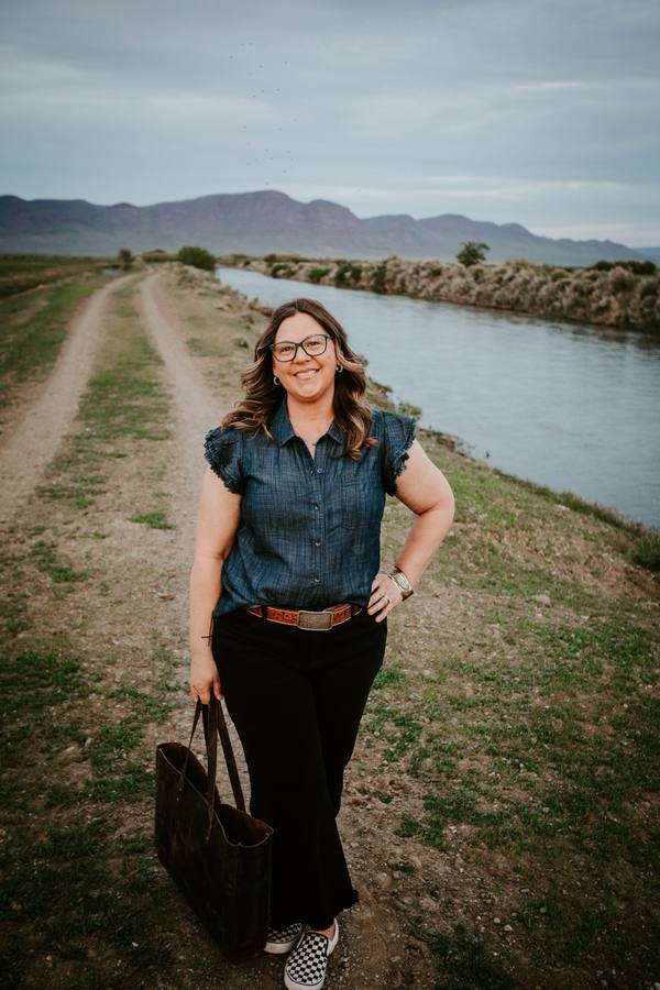 Rachel walking on a dirt path with bag in hand